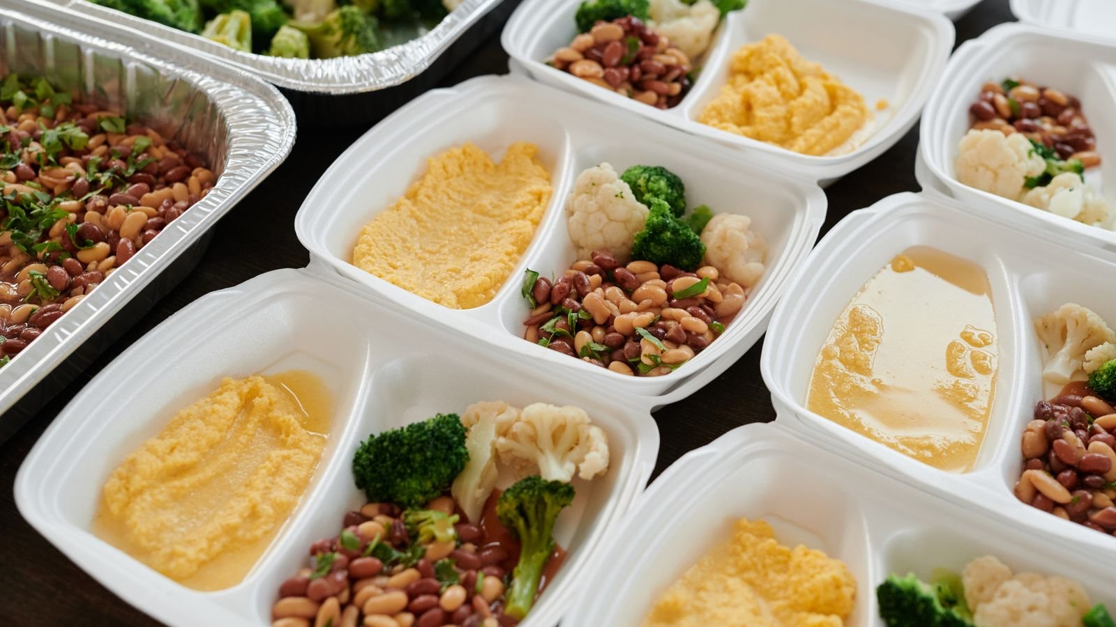 Balanced meal-prep containers with beans, broccoli, vegetables and potatoes for eating-window meals